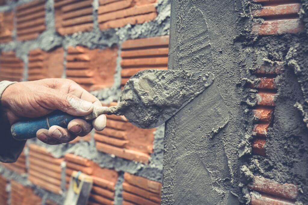 bricklaying-construction-worker-building-brick-wall